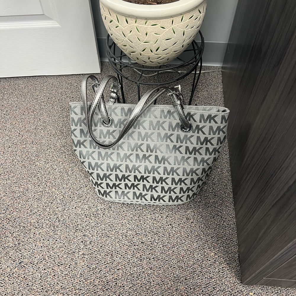 Michael Kors. New with tags. Grey/Peuter MK embossed leather purse.
